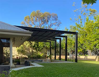 Bright blue sky and lush green grass featuring a black, Kenlow outdoor shade