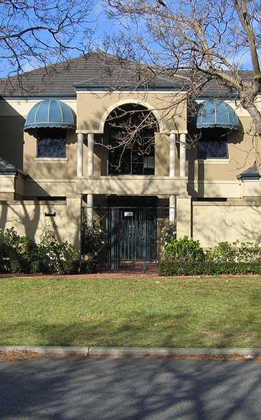 Large residential home with kenlow awnings on second level windows