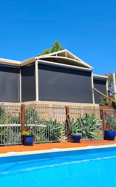 Dark Ziptrak blinds overlooking pool area from Kenlow