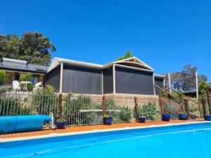 Kenlow home exterior black outdoor blinds in pool area