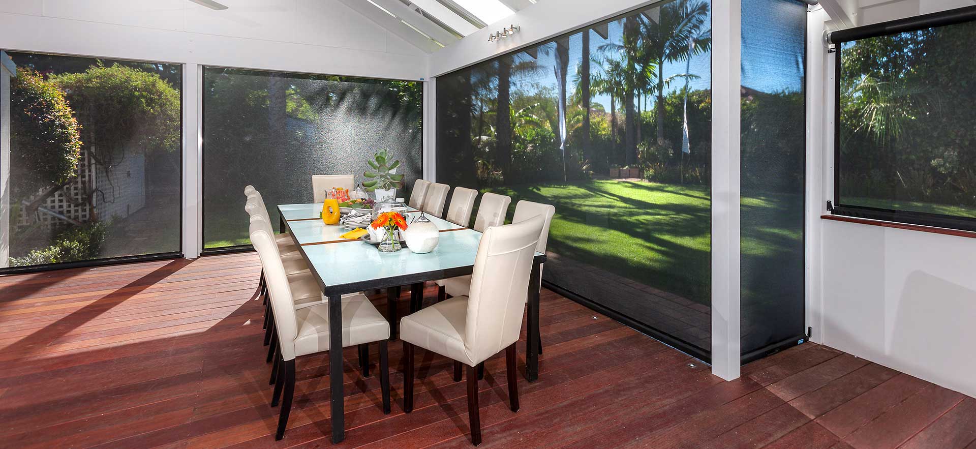 Outdoor dining area during day time with black retractable blinds