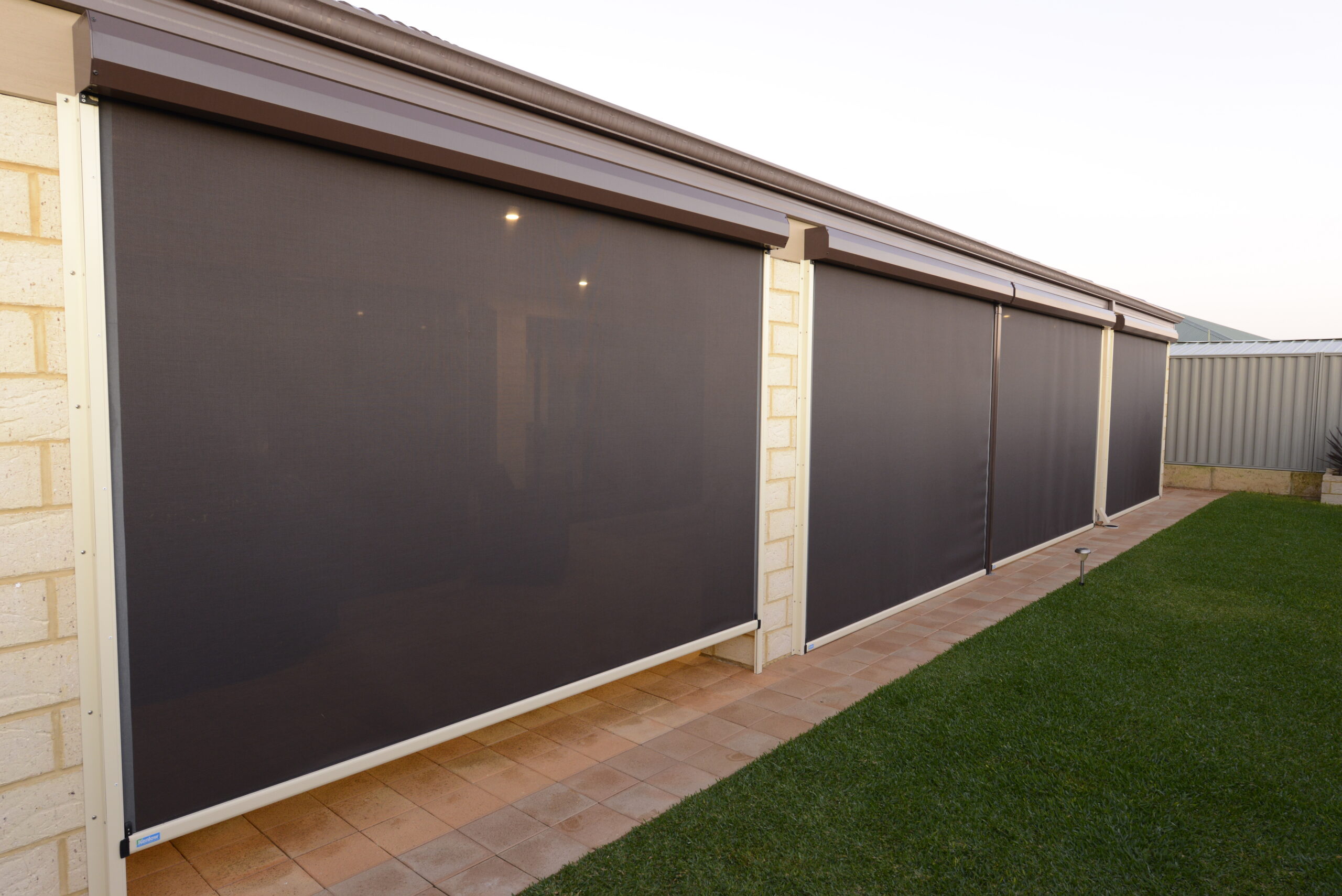 Charcoal Ziptrak mesh outdoor blinds installed on a Perth residential patio by Kenlow