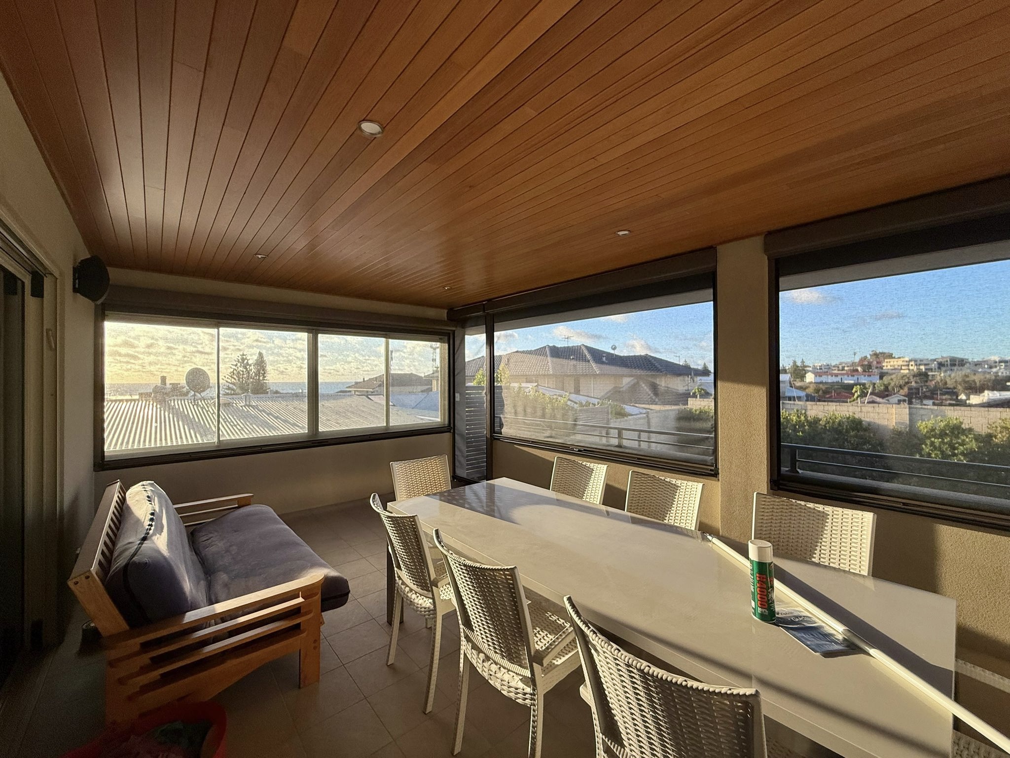 Enclosed upper-storey balcony with charcoal Ziptrak mesh blinds providing coastal views and wind protection, installed by Kenlow in Perth